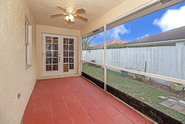 unfurnished sunroom with french doors and ceiling fan