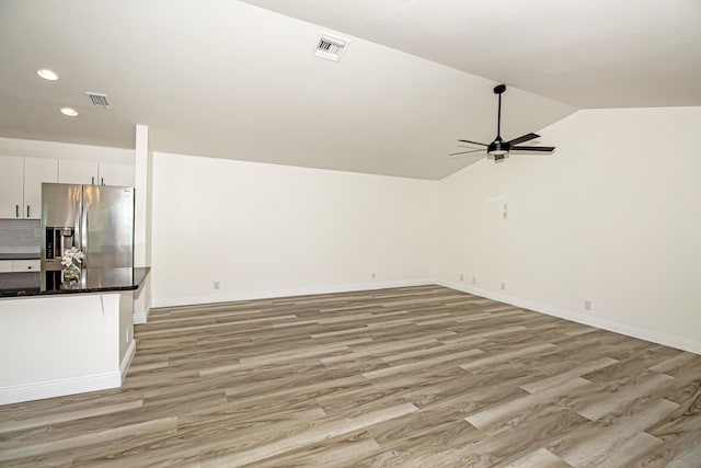 interior space featuring lofted ceiling, light hardwood / wood-style floors, and ceiling fan