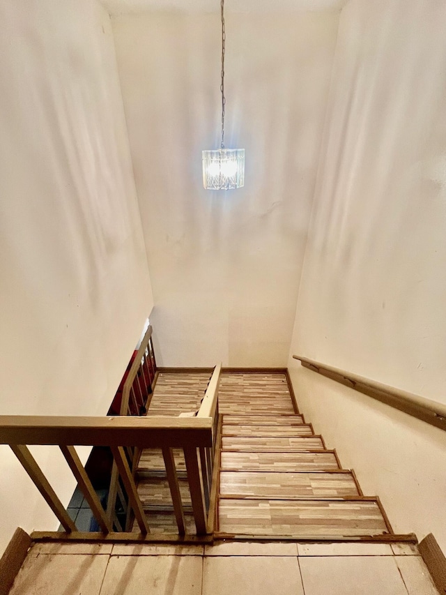 stairway with an inviting chandelier