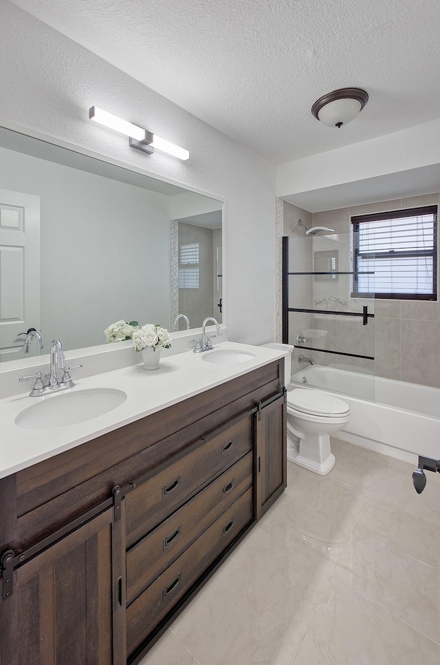 bathroom featuring toilet, a sink, shower / bathing tub combination, and a textured ceiling