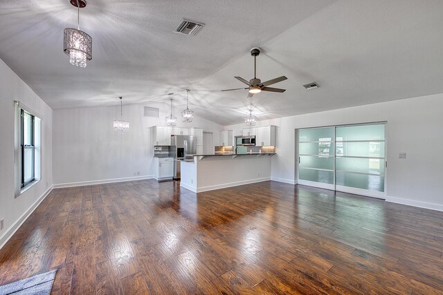 unfurnished room with a textured ceiling, dark wood-style flooring, a ceiling fan, and baseboards