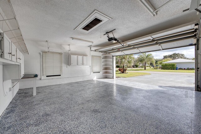 garage featuring a garage door opener and washer and dryer