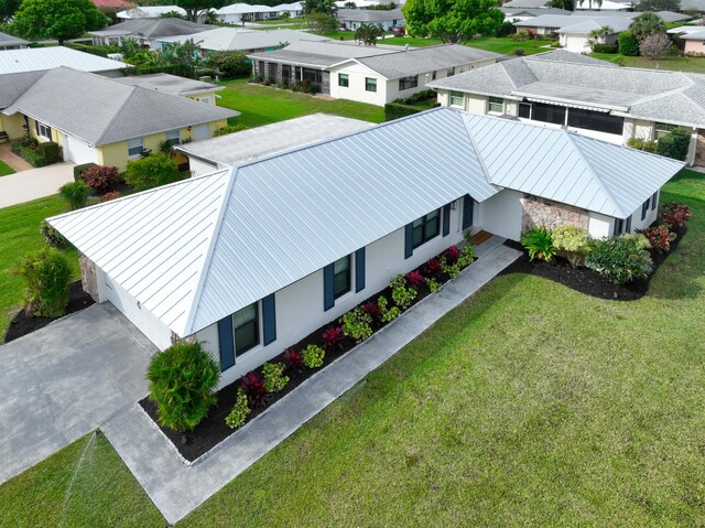 ranch-style home with a garage, driveway, and a front yard