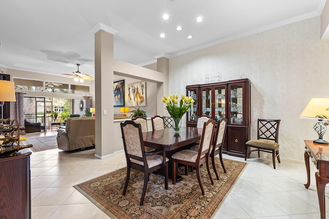 dining space with crown molding, ceiling fan, and light tile patterned floors