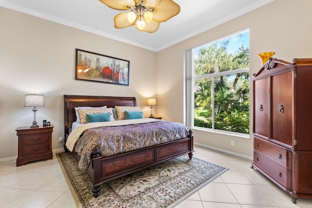 tiled bedroom with ornamental molding and ceiling fan