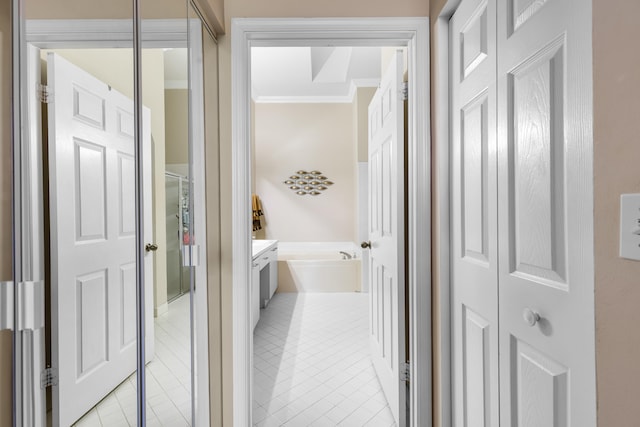 hall with crown molding and light tile patterned flooring