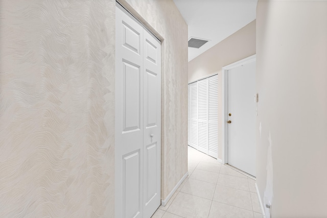 hall featuring light tile patterned floors