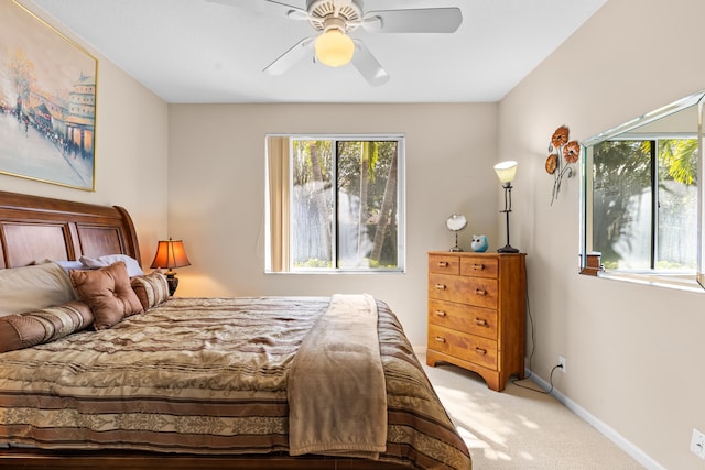 bedroom featuring light colored carpet and ceiling fan