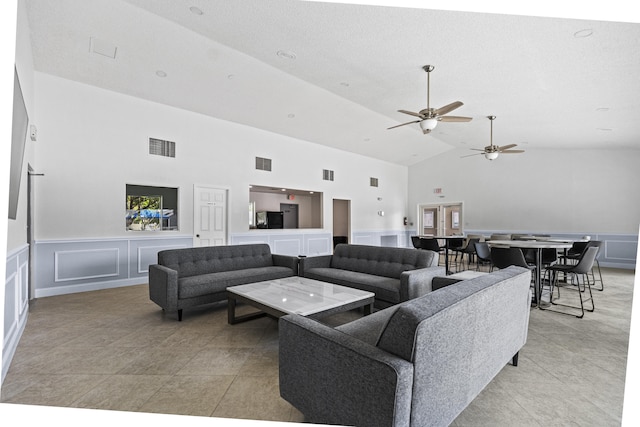 living room featuring high vaulted ceiling and light tile patterned floors