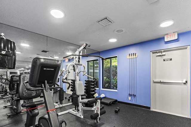 gym with a textured ceiling