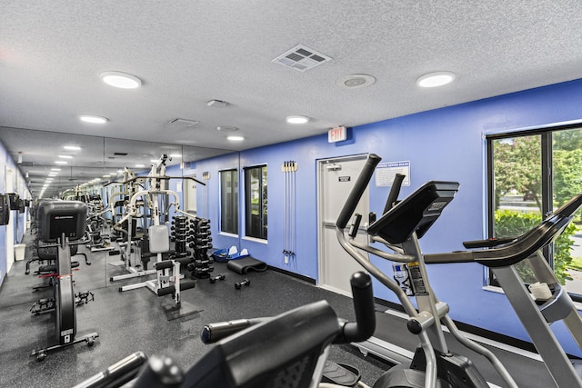 exercise room with a textured ceiling