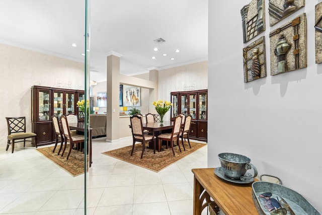 tiled dining space featuring ornamental molding