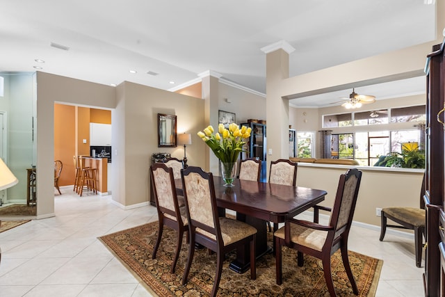 tiled dining area featuring crown molding and ceiling fan