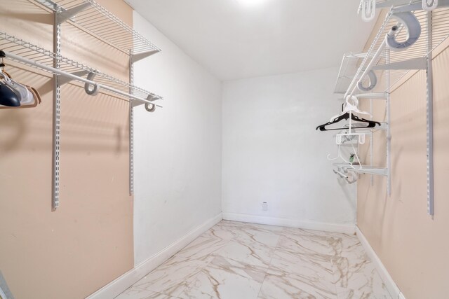 unfurnished bedroom with a ceiling fan, baseboards, and a closet