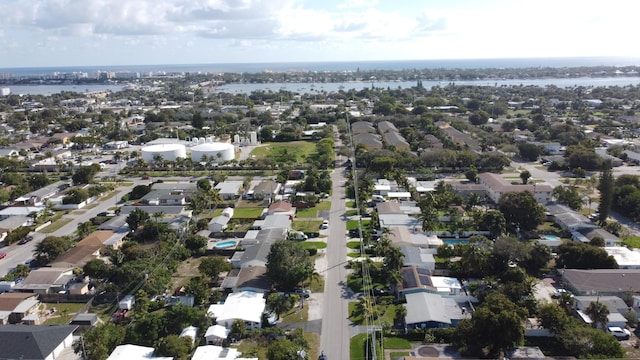 drone / aerial view with a water view and a residential view
