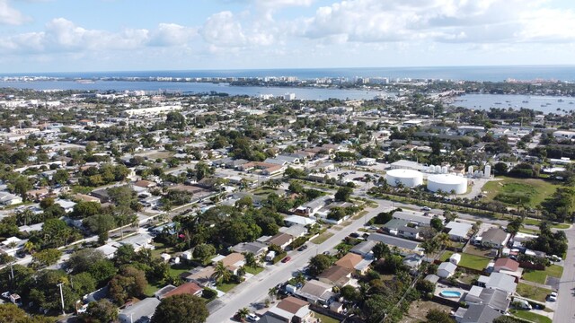birds eye view of property with a water view and a residential view