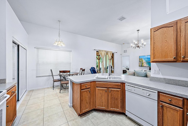 kitchen featuring sink, white appliances, a notable chandelier, decorative light fixtures, and kitchen peninsula