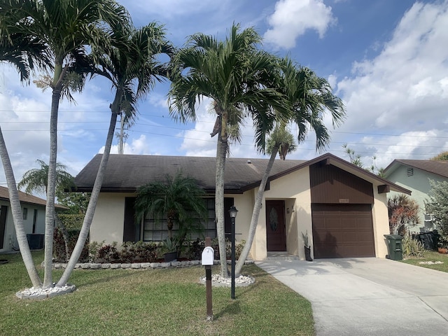 single story home with a garage and a front yard