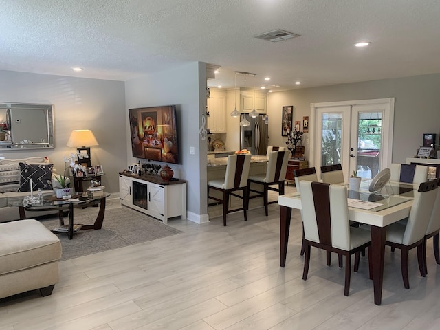 6247 Red Cedar Cir, Greenacres, FL 33463 - dining room featuring visible vents, baseboards, light wood-style flooring, and arched walkways