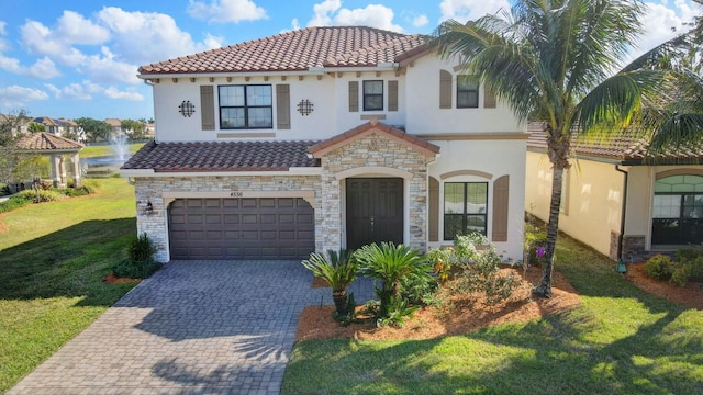 mediterranean / spanish-style house featuring a garage and a front lawn