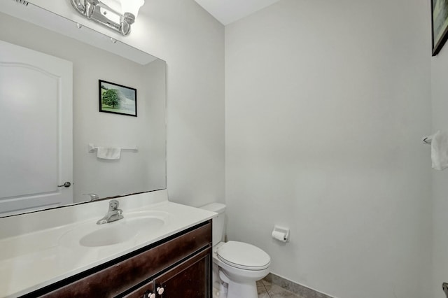 bathroom with vanity, toilet, and tile patterned flooring