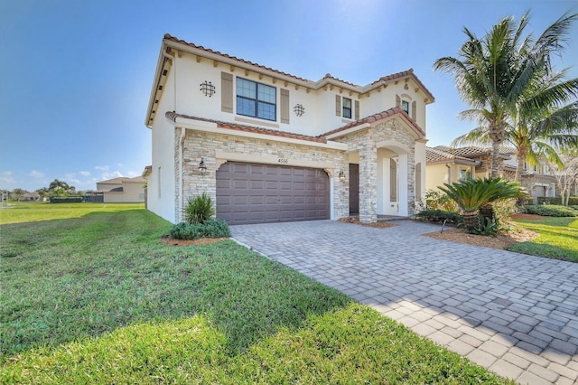 mediterranean / spanish home featuring a garage and a front lawn