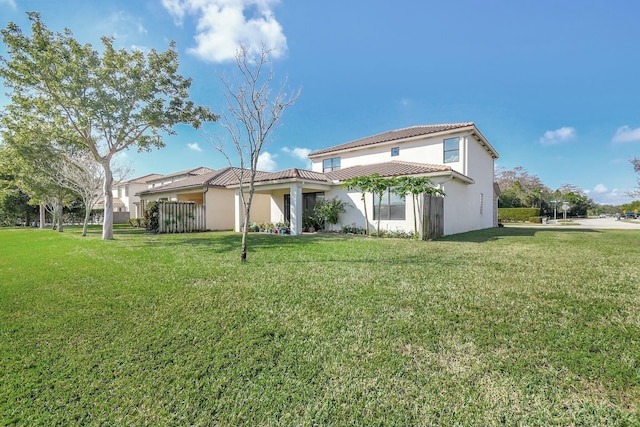 back of house with a lawn