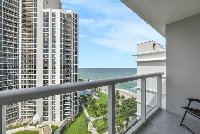 balcony featuring a water view and a view of the beach