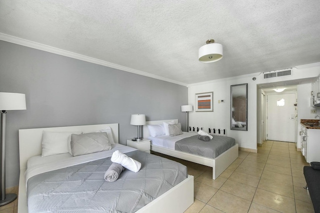 bedroom featuring ornamental molding, a textured ceiling, and light tile patterned floors