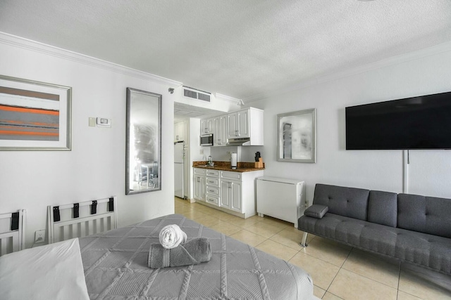 interior space with crown molding, a textured ceiling, and light tile patterned flooring