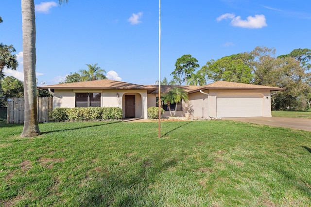 single story home featuring a garage and a front yard