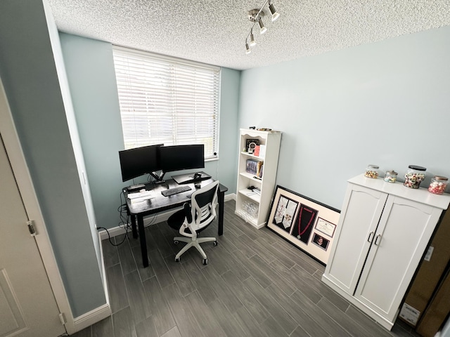 office featuring track lighting and a textured ceiling