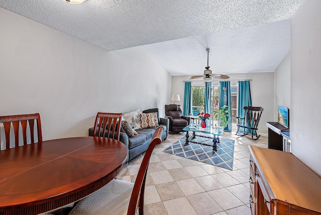 tiled dining space featuring a textured ceiling and ceiling fan