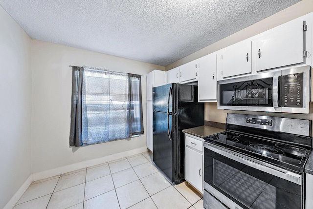 kitchen with white cabinetry, appliances with stainless steel finishes, a textured ceiling, and light tile patterned floors