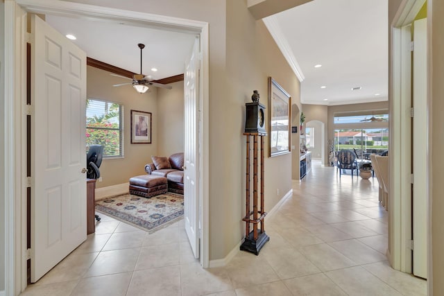 hallway featuring crown molding and light tile patterned floors