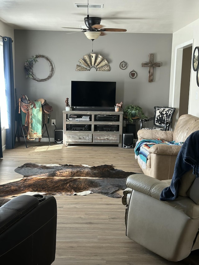 living room featuring hardwood / wood-style flooring and ceiling fan