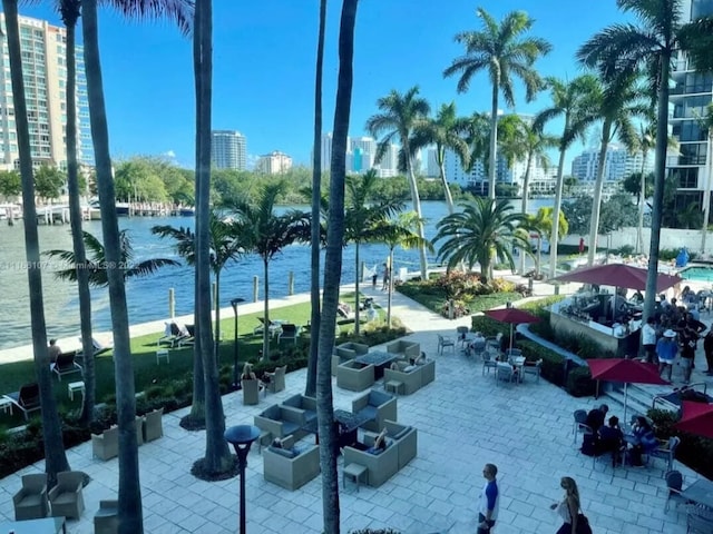 view of property's community with a patio and a water view