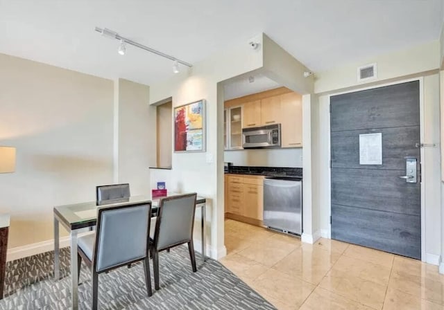 tiled dining area with rail lighting