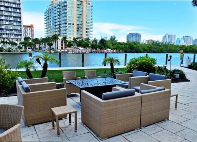 view of patio with a water view and an outdoor living space