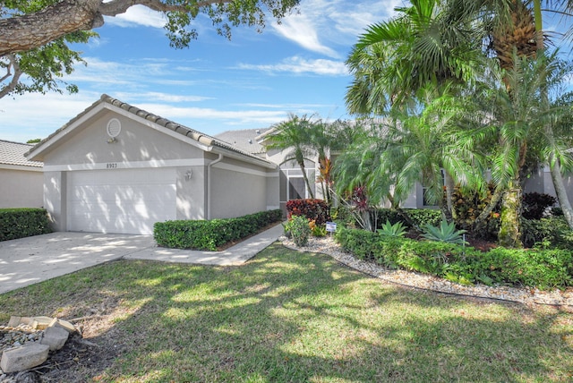 ranch-style house with a garage and a front yard