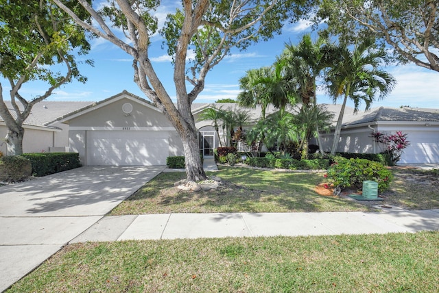 view of front of home with a garage and a front lawn