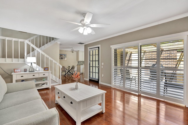 living room featuring ceiling fan, wood-type flooring, and ornamental molding