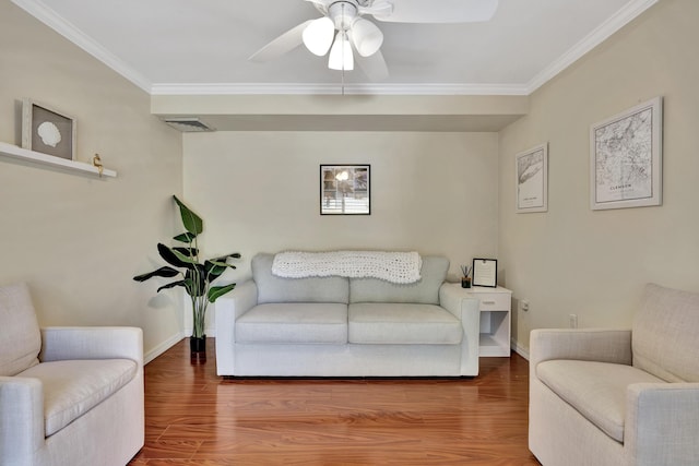 living room with ceiling fan, crown molding, and wood-type flooring