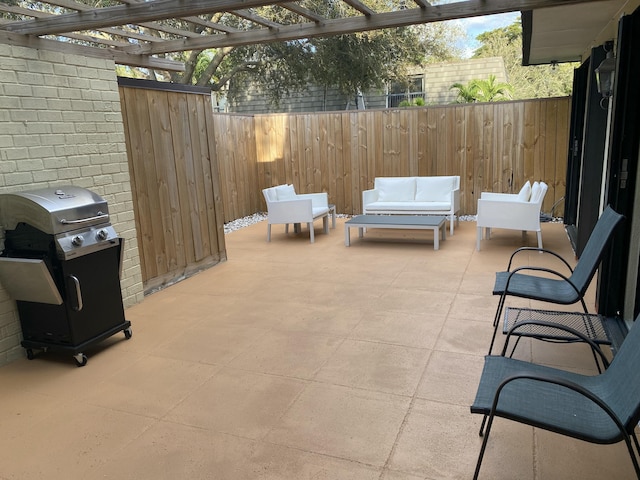 view of patio with an outdoor living space, a pergola, and a grill