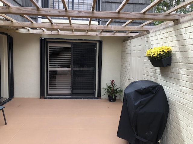 view of patio featuring a pergola and a grill