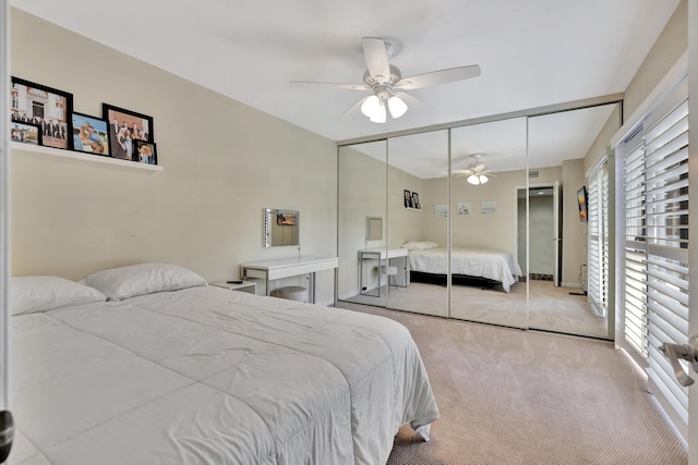 carpeted bedroom featuring a closet and ceiling fan