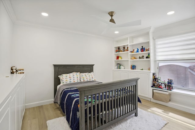 bedroom featuring ceiling fan, ornamental molding, and light wood-type flooring