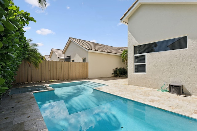 view of swimming pool featuring central AC unit and a patio area