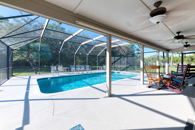 view of pool with a lanai, ceiling fan, and a patio area