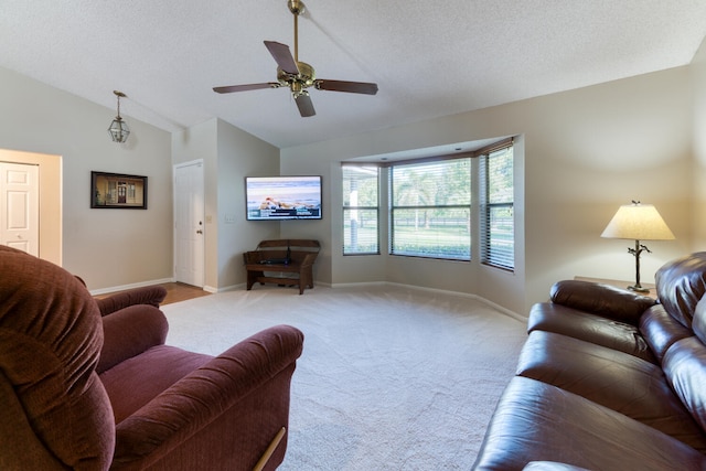 living room featuring ceiling fan, vaulted ceiling, light colored carpet, and a textured ceiling